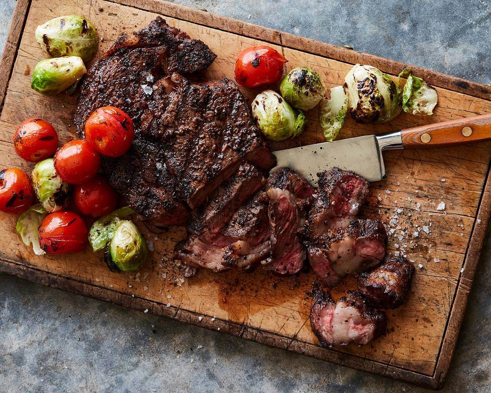 Pepper-Crusted Ribeyes With Grilled Brussels & Tomatoes